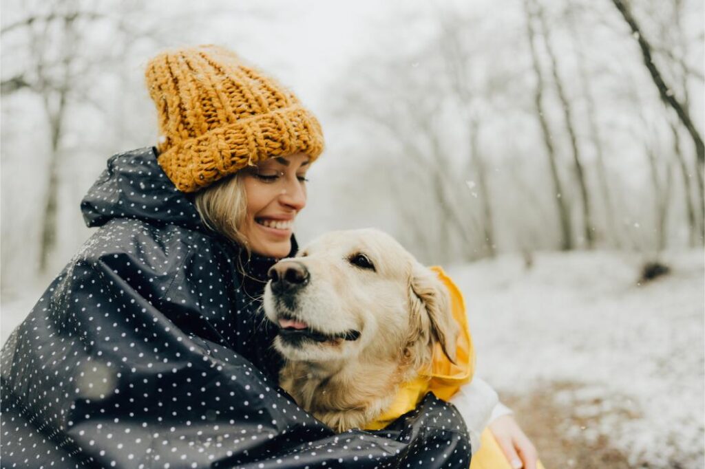 dog cuddled with owner in winter.